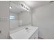 Bathroom featuring a large mirror, vanity with storage, and neutral tile flooring at 2509 W Crawford St, Tampa, FL 33614
