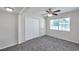 Cozy bedroom features neutral carpet, ceiling fan, double closet, and bright window at 2509 W Crawford St, Tampa, FL 33614