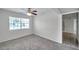 Bright, carpeted bedroom with a large window and view of the neighborhood at 2509 W Crawford St, Tampa, FL 33614