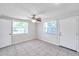 Spacious bedroom boasts tiled floors, a ceiling fan, and bright windows at 2509 W Crawford St, Tampa, FL 33614