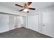 Bedroom featuring neutral carpet, ceiling fan, and doors to the bathroom and closet at 2509 W Crawford St, Tampa, FL 33614