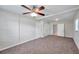 Inviting bedroom with large closets, neutral tones, carpet, and ceiling fan at 2509 W Crawford St, Tampa, FL 33614