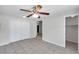 A bright bedroom features tile floors, a ceiling fan, and a double door closet at 2509 W Crawford St, Tampa, FL 33614