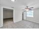 Bedroom featuring tiled flooring, a ceiling fan, and a doorway to another room at 2509 W Crawford St, Tampa, FL 33614