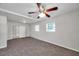 Cozy bedroom features neutral carpet, a ceiling fan, and windows for natural light at 2509 W Crawford St, Tampa, FL 33614