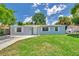 Well-kept single-story home with lush green lawn, offering a cozy and welcoming curb appeal at 2509 W Crawford St, Tampa, FL 33614