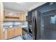 A kitchen features light wood cabinets, a black refrigerator, and solid surface countertops at 2509 W Crawford St, Tampa, FL 33614