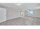 The open living room has neutral walls and matching neutral tile floors at 2509 W Crawford St, Tampa, FL 33614