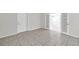 Bright, open living area with tile flooring, white walls, and double french doors at 2509 W Crawford St, Tampa, FL 33614