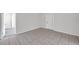 Tiled living space with a fresh look, featuring neutral tones and an open doorway at 2509 W Crawford St, Tampa, FL 33614