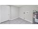 The utility room features gray tile flooring and access to the backyard at 2509 W Crawford St, Tampa, FL 33614