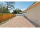 Brick-paved backyard patio features a view of the fence, landscaping and exterior at 2625 Brookville Dr, Valrico, FL 33596