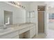 Bathroom featuring a double sink vanity, large mirror and a glass shower at 2625 Brookville Dr, Valrico, FL 33596