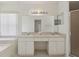 Bright bathroom featuring a double sink vanity, a large mirror and a separate shower stall at 2625 Brookville Dr, Valrico, FL 33596