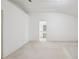 Spacious primary bedroom with neutral walls, with an open view into the primary bathroom at 2625 Brookville Dr, Valrico, FL 33596