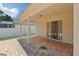 The brick-paved covered patio opens up to the backyard through sliding glass doors, creating a seamless transition at 2625 Brookville Dr, Valrico, FL 33596