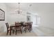 Dining room with a chandelier, plush carpet and plenty of space for entertaining guests at 2625 Brookville Dr, Valrico, FL 33596