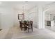 Dining room with views of the kitchen, plush carpet, and a chandelier at 2625 Brookville Dr, Valrico, FL 33596