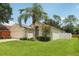 Single-story home with attached two car garage, a well-maintained lawn, and mature landscaping at 2625 Brookville Dr, Valrico, FL 33596
