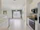 Open-concept layout showcasing the kitchen with stainless appliances and a view into the living space with ample natural light at 2625 Brookville Dr, Valrico, FL 33596