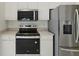 Updated kitchen with stainless steel appliances and white cabinets offering a modern and functional space at 2625 Brookville Dr, Valrico, FL 33596