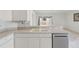 Kitchen featuring a stainless steel dishwasher, a double bowl sink, and white cabinets with bar top counter at 2625 Brookville Dr, Valrico, FL 33596