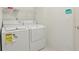 Modern laundry room equipped with white washer and dryer units at 2625 Brookville Dr, Valrico, FL 33596