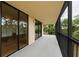 Wide outdoor balcony with black railings, offering serene views of surrounding trees and greenery at 3062 Eastland Blvd # 308, Clearwater, FL 33761