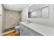 Bathroom featuring a modern vanity, quartz counters, updated fixtures, and marble-look shower at 3062 Eastland Blvd # 308, Clearwater, FL 33761