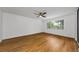 Bright bedroom featuring neutral colors, a ceiling fan, and a large window at 3062 Eastland Blvd # 308, Clearwater, FL 33761