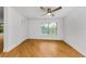 Bright bedroom with a ceiling fan, a large window, and wood-style flooring at 3062 Eastland Blvd # 308, Clearwater, FL 33761