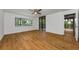 Bright bedroom with hardwood floors, ceiling fan, and sliding glass doors to a balcony at 3062 Eastland Blvd # 308, Clearwater, FL 33761
