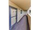 Hallway featuring carpet and exterior entrance to condo with natural light at 3062 Eastland Blvd # 308, Clearwater, FL 33761
