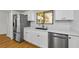 Kitchen with white cabinets, stainless steel appliances, and modern fixtures at 3062 Eastland Blvd # 308, Clearwater, FL 33761