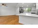 Open-concept kitchen with stainless steel appliances, white cabinets, and a breakfast bar at 3062 Eastland Blvd # 308, Clearwater, FL 33761