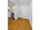 Kitchen with hardwood floor, stainless steel dishwasher, and white cabinets at 3062 Eastland Blvd # 308, Clearwater, FL 33761