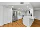Kitchen features white cabinets, stainless steel appliances and hardwood flooring at 3062 Eastland Blvd # 308, Clearwater, FL 33761