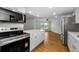 Open kitchen with new stainless steel appliances and hardwood floors at 3062 Eastland Blvd # 308, Clearwater, FL 33761