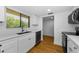 Bright kitchen features white cabinets, stainless steel appliances, and wood flooring at 3062 Eastland Blvd # 308, Clearwater, FL 33761