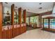 Lounge area with a bookcase, tiled floors, and views of the pool at 3062 Eastland Blvd # 308, Clearwater, FL 33761