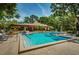 Community pool featuring lounge chairs and umbrellas offers a great place to relax and enjoy the Florida sunshine at 3062 Eastland Blvd # 308, Clearwater, FL 33761