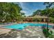 Enjoy the community pool, a perfect place to relax and socialize with covered seating and lush landscaping at 3062 Eastland Blvd # 308, Clearwater, FL 33761