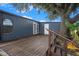 Wooden deck with steps and lush backyard with banana tree at 3125 Beaver Creek Dr, Wesley Chapel, FL 33543