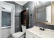 Nicely appointed bathroom with updated vanity, toilet and built in shelves for convenient storage at 3125 Beaver Creek Dr, Wesley Chapel, FL 33543
