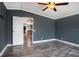 Bedroom with ceiling fan, neutral colors and an open doorway view into the kitchen at 3125 Beaver Creek Dr, Wesley Chapel, FL 33543