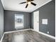 Comfortable bedroom featuring a ceiling fan, natural light, and neutral colors at 3125 Beaver Creek Dr, Wesley Chapel, FL 33543