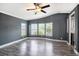 Bright bedroom featuring ceiling fan, neutral colors and large windows to let in natural light at 3125 Beaver Creek Dr, Wesley Chapel, FL 33543