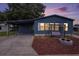 Charming blue home with a cozy porch swing and fire pit in a peaceful community at 3125 Beaver Creek Dr, Wesley Chapel, FL 33543
