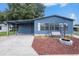 Charming blue home with a cozy porch swing and fire pit in a peaceful community at 3125 Beaver Creek Dr, Wesley Chapel, FL 33543