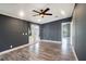 A modern living room features gray walls, white trim, wood-look flooring, and French doors to the outside at 3125 Beaver Creek Dr, Wesley Chapel, FL 33543